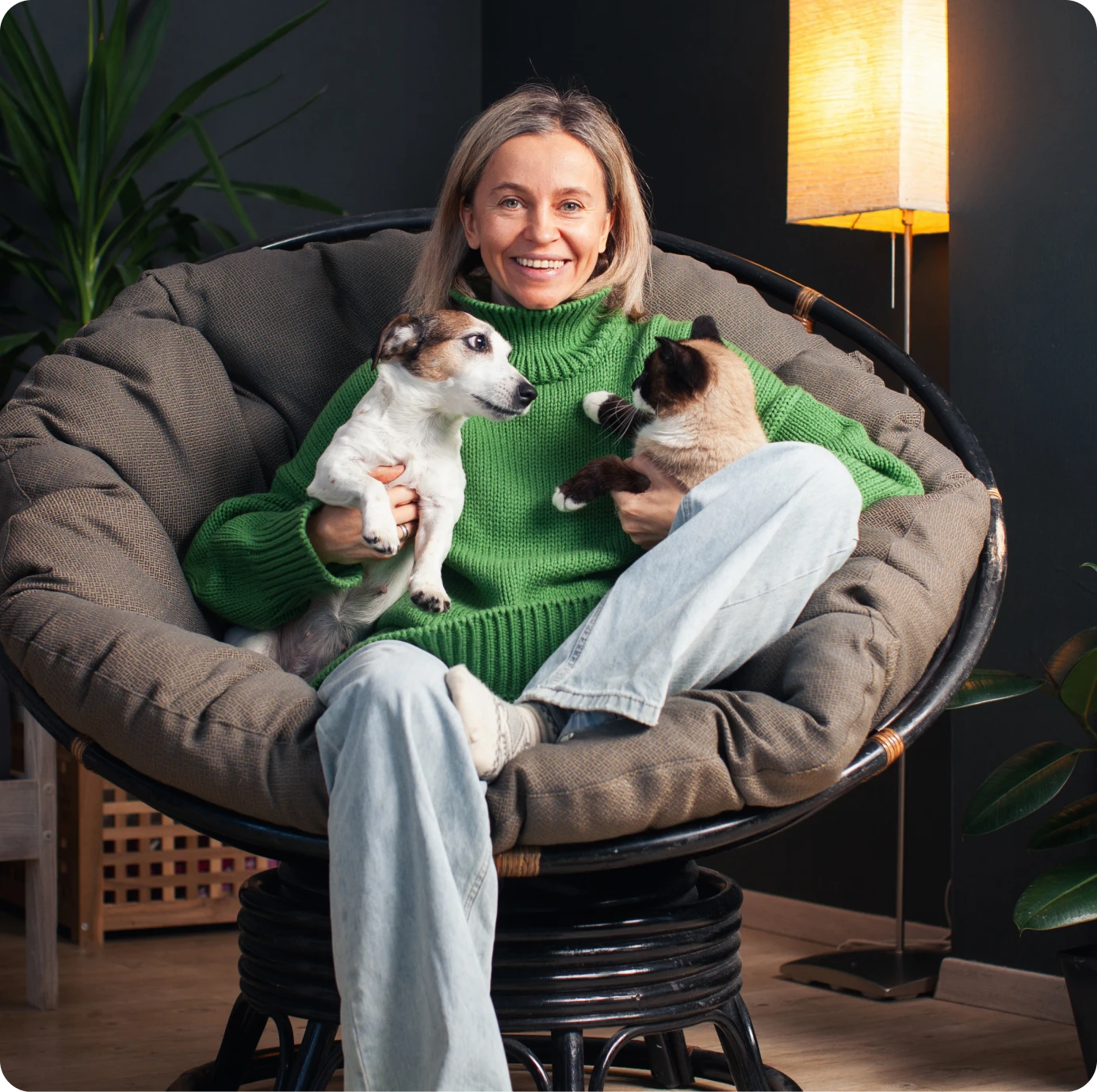 Woman sitting with dog and cat